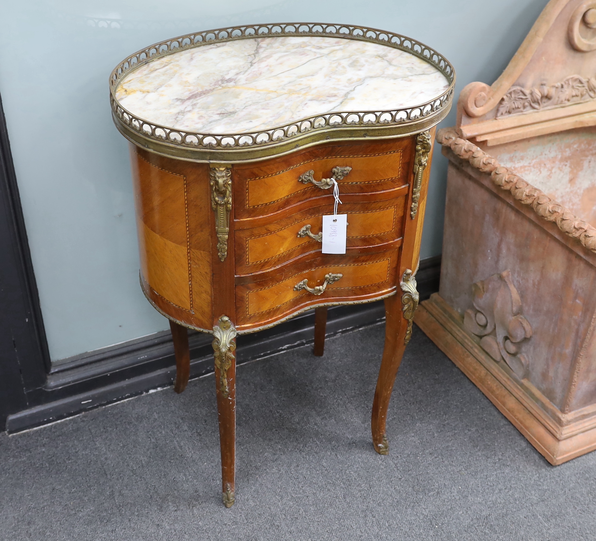 A Louis XVI style marble topped kidney shaped kingwood three drawer side table, width 52cm, depth 38cm, height 73cm